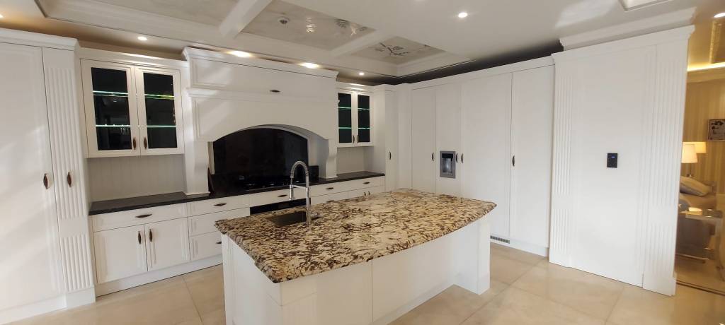 Modern kitchen renovation with white cabinets and stone countertop

Kitchen renovation design showing elegant white cabinetry and granite island

Example of modern kitchen renovation project with stylish cabinets and countertop