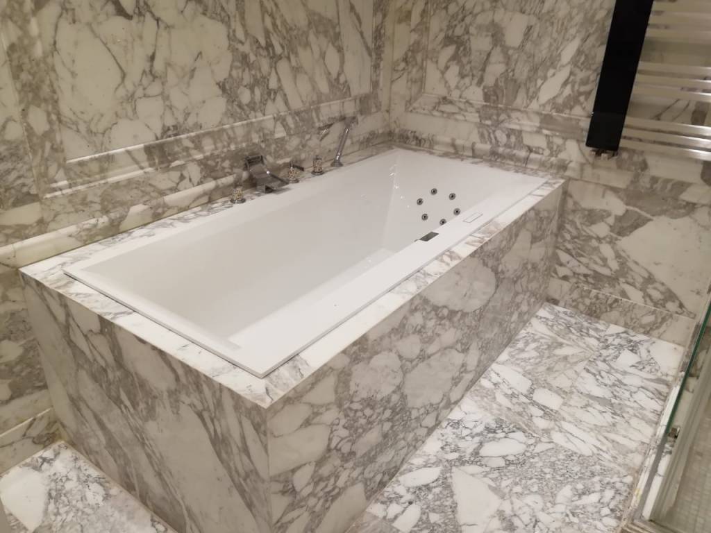 Luxurious marble bathtub design with modern finish, part of a bathroom renovation project