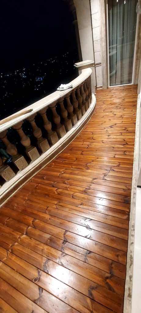 Balcony renovation completed with elegant wooden flooring for a modern outdoor look
