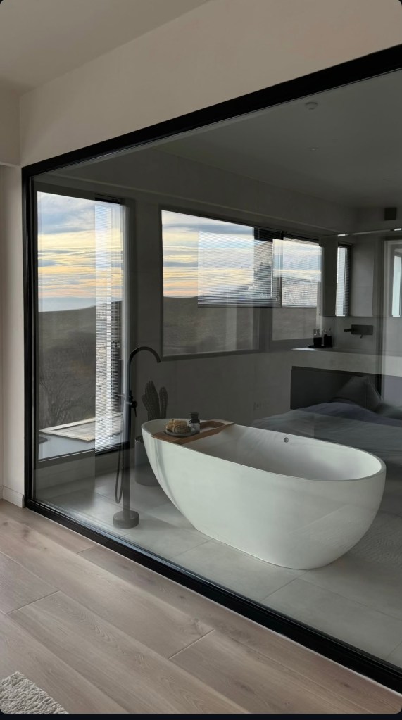 Luxury bathroom renovation with a modern freestanding bathtub, large windows, and natural light in the Netherlands