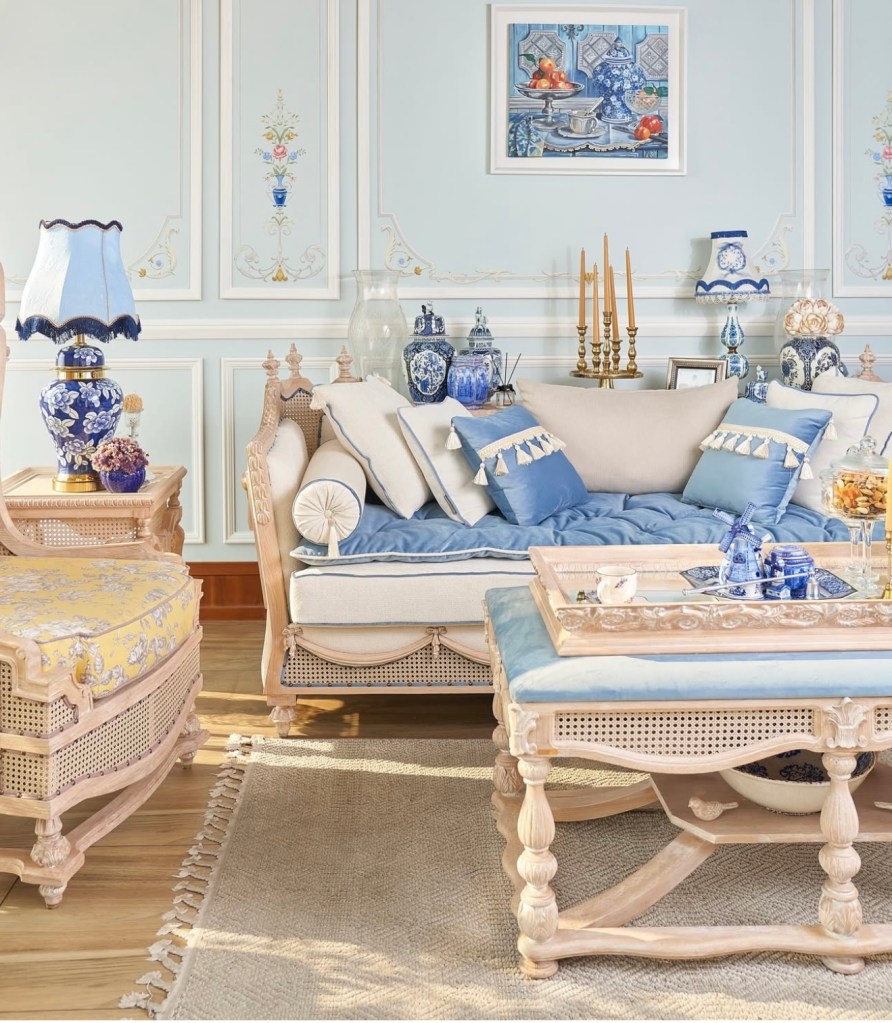 Elegant living room interior with classic wooden furniture, blue and beige cushions, and luxury decorative accessories