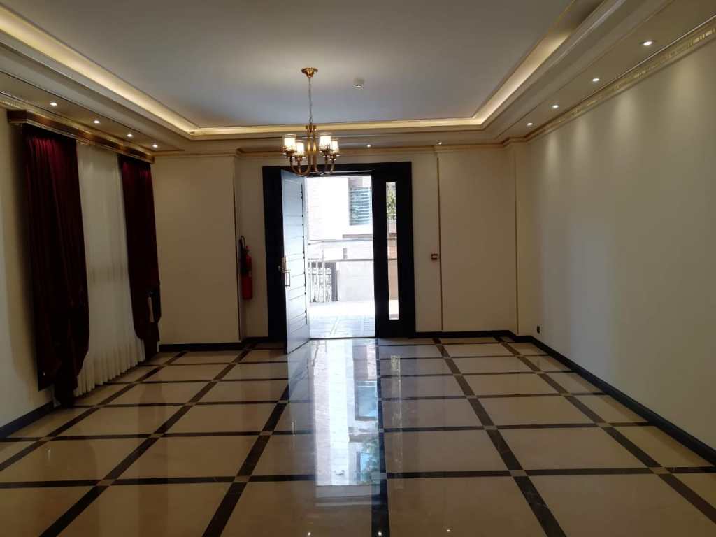 Spacious renovated lobby featuring polished marble, high ceilings, and stylish lighting