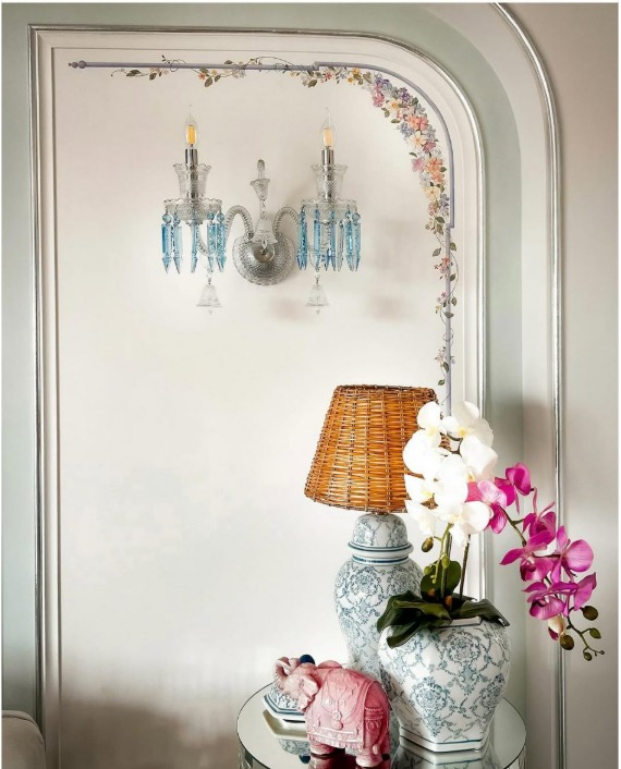Decorative wall painting with floral details and classic wall light